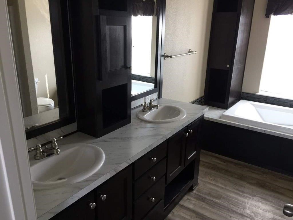The ING682F MAPLE        (FULL) GW Primary Bathroom. This Manufactured Mobile Home features 4 bedrooms and 2 baths.